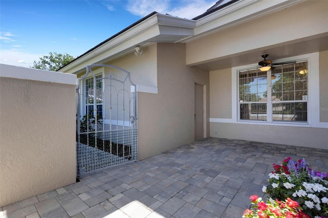 4044 Penshurst Park, Sarasota, FL 34235 - property entrance featuring a patio, stucco siding, and ceiling fan