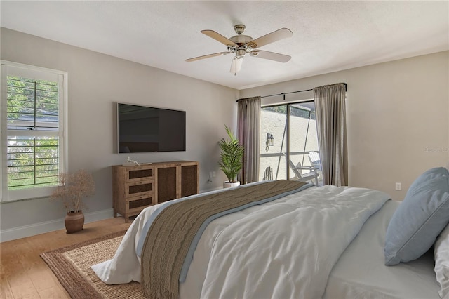 bedroom with baseboards, a ceiling fan, and wood finished floors