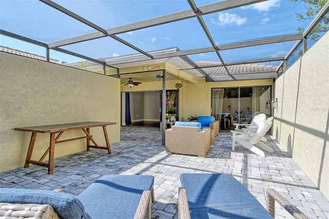 view of patio / terrace with a ceiling fan, a lanai, and an outdoor living space