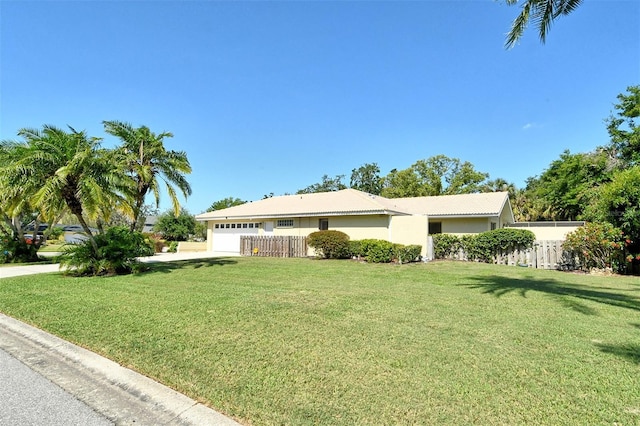 view of home's exterior featuring fence, a yard, and a garage