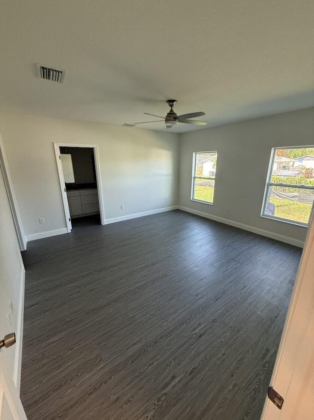 8810 N Mulberry St, Tampa, FL 33604 - spare room with a ceiling fan, baseboards, dark wood-style floors, and visible vents