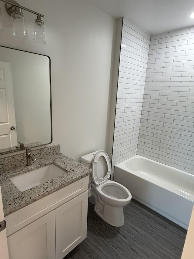 8810 N Mulberry St, Tampa, FL 33604 - full bath featuring shower / washtub combination, vanity, toilet, and wood finished floors