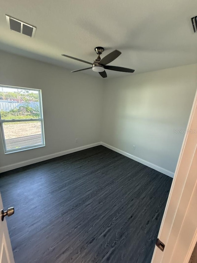 8810 N Mulberry St, Tampa, FL 33604 - unfurnished room featuring dark wood-type flooring, visible vents, baseboards, and ceiling fan