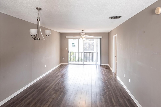 2300 Stickney Point Rd Unit 125, Sarasota, FL 34231 - empty room with a textured ceiling, dark wood-type flooring, baseboards, a chandelier, and ceiling fan