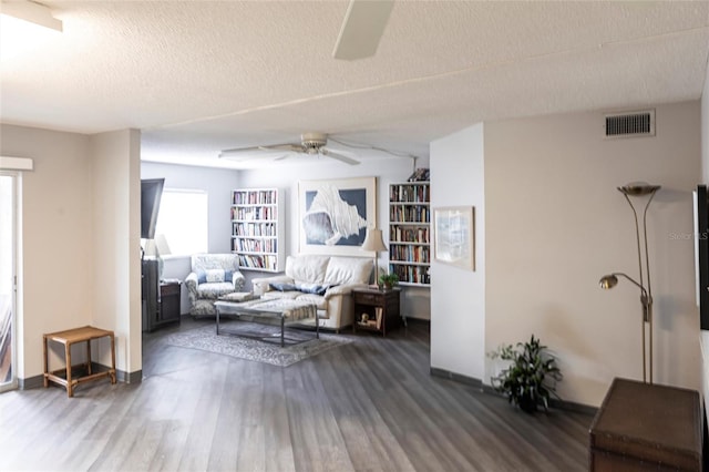 2300 Stickney Point Rd Unit 125, Sarasota, FL 34231 - living room with a ceiling fan, wood finished floors, a textured ceiling, and baseboards