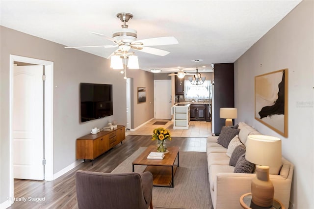 2300 Stickney Point Rd Unit 125, Sarasota, FL 34231 - living area with baseboards, a ceiling fan, and light wood-style floors