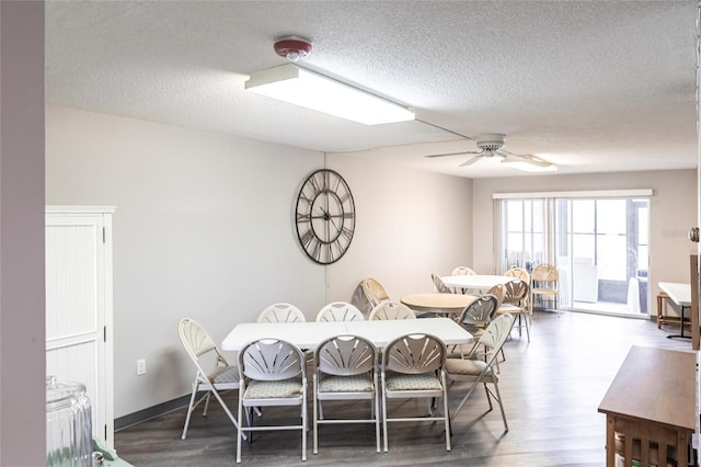 2300 Stickney Point Rd Unit 125, Sarasota, FL 34231 - dining room with a textured ceiling, wood finished floors, and a ceiling fan