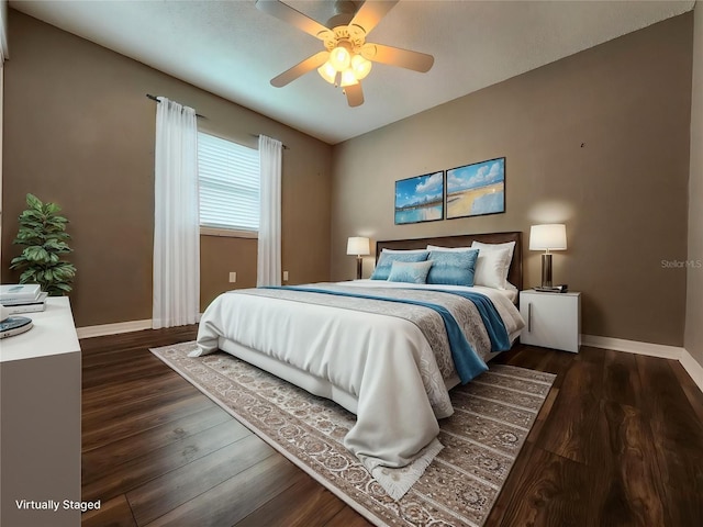 2300 Stickney Point Rd Unit 125, Sarasota, FL 34231 - bedroom featuring baseboards, dark wood-style flooring, and a ceiling fan