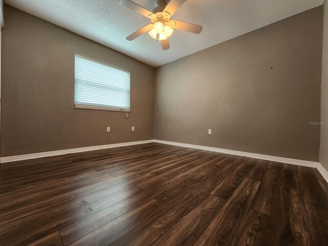 2300 Stickney Point Rd Unit 125, Sarasota, FL 34231 - unfurnished room with dark wood finished floors, baseboards, a textured ceiling, and a ceiling fan