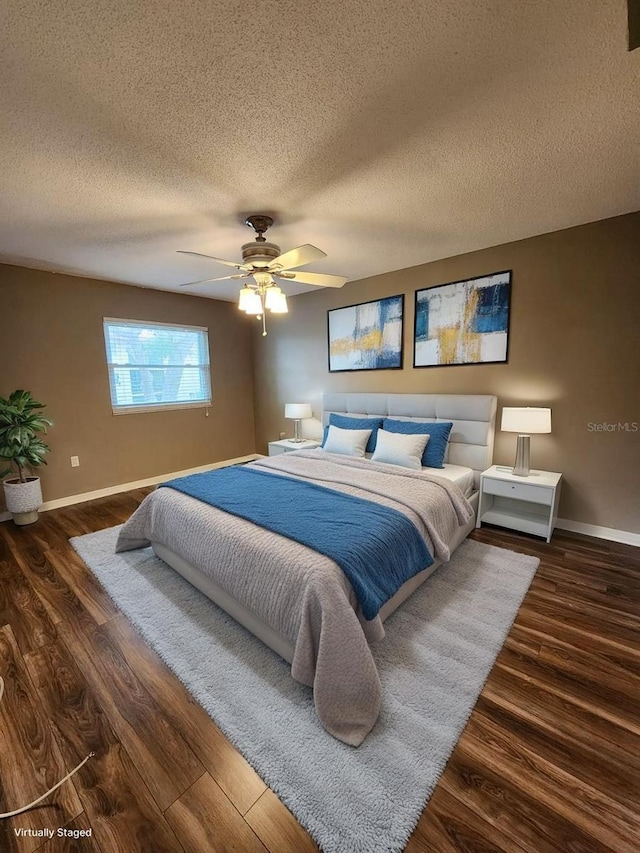 2300 Stickney Point Rd Unit 125, Sarasota, FL 34231 - bedroom featuring baseboards, wood finished floors, a textured ceiling, and ceiling fan