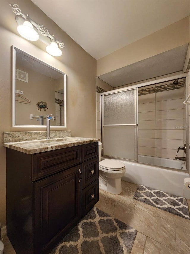 2300 Stickney Point Rd Unit 125, Sarasota, FL 34231 - full bath featuring toilet, vanity, and bath / shower combo with glass door