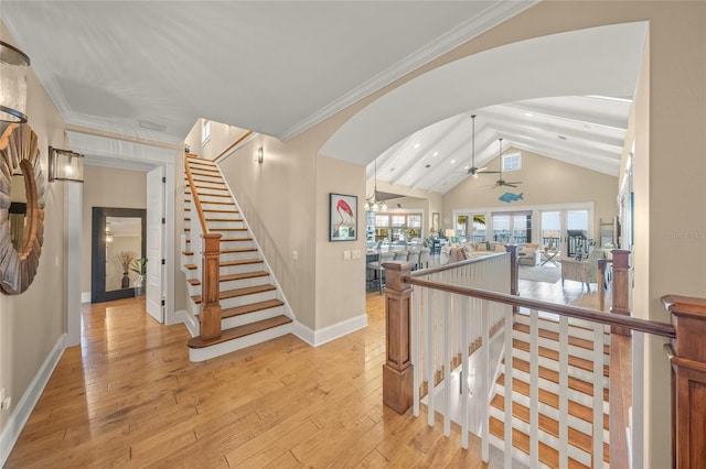 526 56th St, Holmes Beach, FL 34217 - stairs with arched walkways, wood-type flooring, ceiling fan, and lofted ceiling