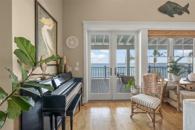 526 56th St, Holmes Beach, FL 34217 - sitting room with a water view, light wood finished floors, and french doors