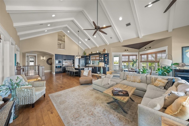 526 56th St, Holmes Beach, FL 34217 - living area with high vaulted ceiling, ceiling fan, arched walkways, visible vents, and dark wood-style floors