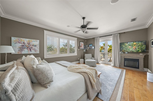 526 56th St, Holmes Beach, FL 34217 - bedroom featuring access to exterior, multiple windows, ornamental molding, and visible vents