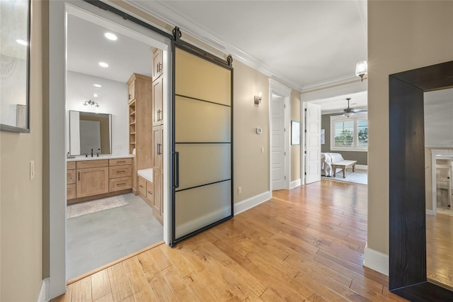 526 56th St, Holmes Beach, FL 34217 - corridor featuring light wood-type flooring, baseboards, and ornamental molding