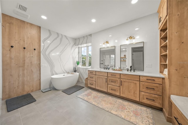 526 56th St, Holmes Beach, FL 34217 - bathroom with a freestanding tub, double vanity, visible vents, and a sink