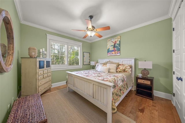 526 56th St, Holmes Beach, FL 34217 - bedroom featuring wood finished floors, baseboards, and ornamental molding