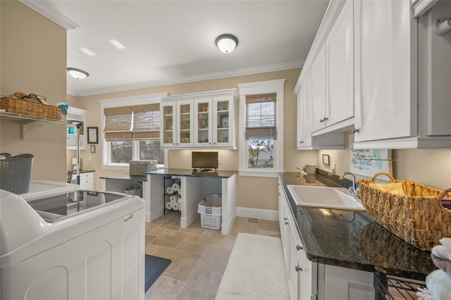 526 56th St, Holmes Beach, FL 34217 - washroom with stone tile floors, washing machine and clothes dryer, ornamental molding, and cabinet space