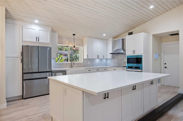 4916 Hidden Oaks Trl, Sarasota, FL 34232 - kitchen featuring appliances with stainless steel finishes, wall chimney exhaust hood, light wood finished floors, white cabinets, and wooden ceiling
