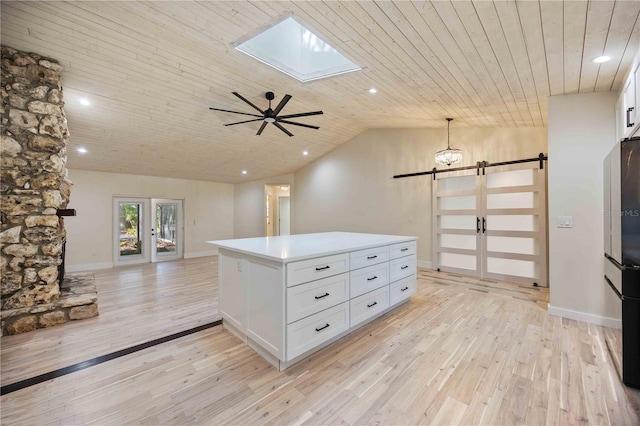 4916 Hidden Oaks Trl, Sarasota, FL 34232 - kitchen featuring a barn door, light wood-type flooring, freestanding refrigerator, open floor plan, and wood ceiling