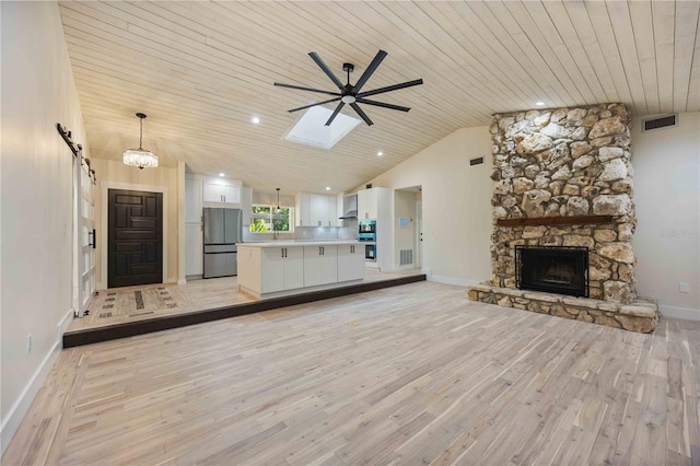 4916 Hidden Oaks Trl, Sarasota, FL 34232 - unfurnished living room with wood ceiling, a ceiling fan, light wood-style flooring, vaulted ceiling, and baseboards