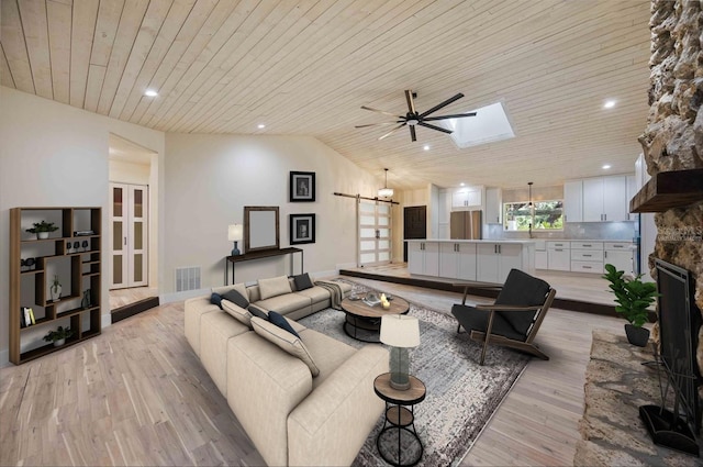 4916 Hidden Oaks Trl, Sarasota, FL 34232 - living room featuring wooden ceiling, light wood-type flooring, ceiling fan, a skylight, and vaulted ceiling