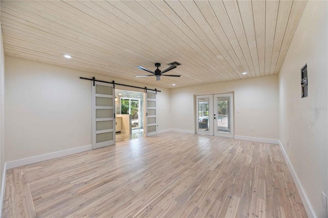 4916 Hidden Oaks Trl, Sarasota, FL 34232 - empty room with a barn door, french doors, light wood-type flooring, wooden ceiling, and plenty of natural light