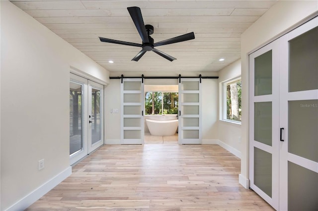 4916 Hidden Oaks Trl, Sarasota, FL 34232 - unfurnished sunroom with french doors and a barn door