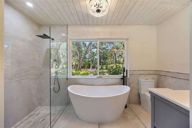 4916 Hidden Oaks Trl, Sarasota, FL 34232 - full bath with a freestanding bath, walk in shower, tile walls, vanity, and toilet