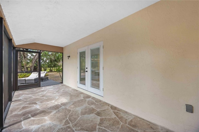 4916 Hidden Oaks Trl, Sarasota, FL 34232 - unfurnished sunroom featuring french doors and vaulted ceiling