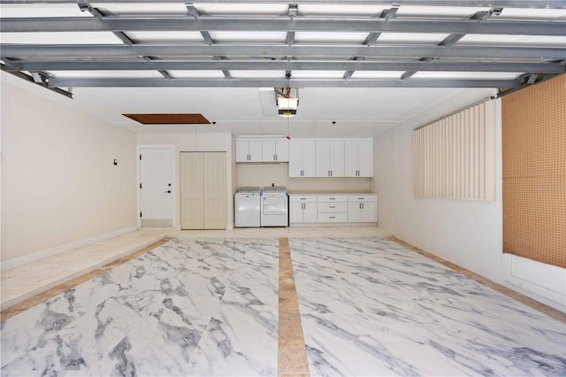 4916 Hidden Oaks Trl, Sarasota, FL 34232 - garage with washer and clothes dryer, a garage door opener, and baseboards