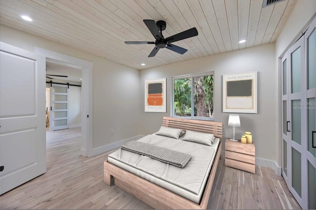 4916 Hidden Oaks Trl, Sarasota, FL 34232 - bedroom featuring a barn door, light wood finished floors, wooden ceiling, baseboards, and recessed lighting