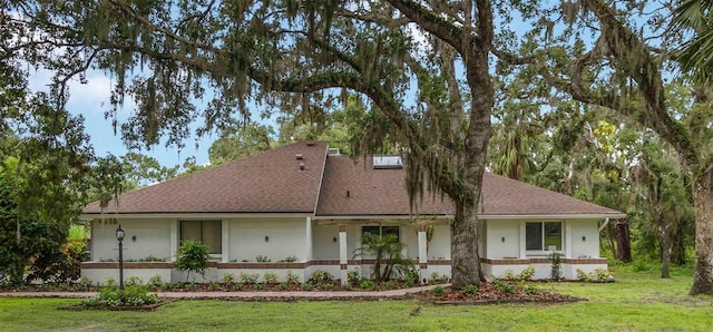 4916 Hidden Oaks Trl, Sarasota, FL 34232 - view of front of home with a front yard, roof with shingles, and stucco siding