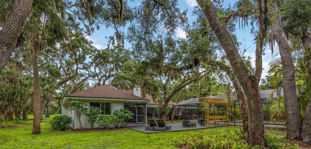 4916 Hidden Oaks Trl, Sarasota, FL 34232 - back of property with a patio area and a yard