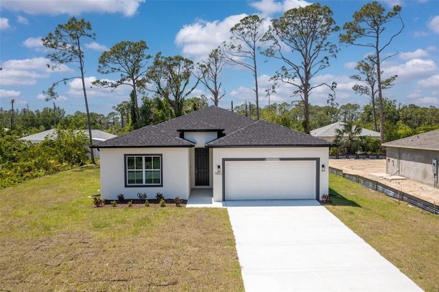 view of front of home featuring concrete driveway, a front lawn, an attached garage, fence, and stucco siding