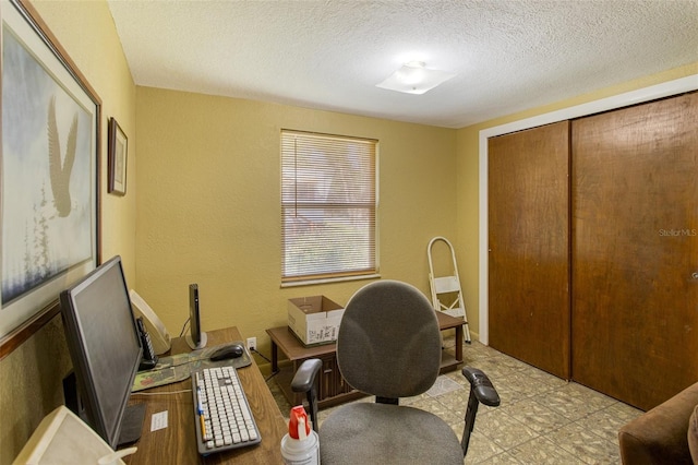 office space with a textured wall and a textured ceiling