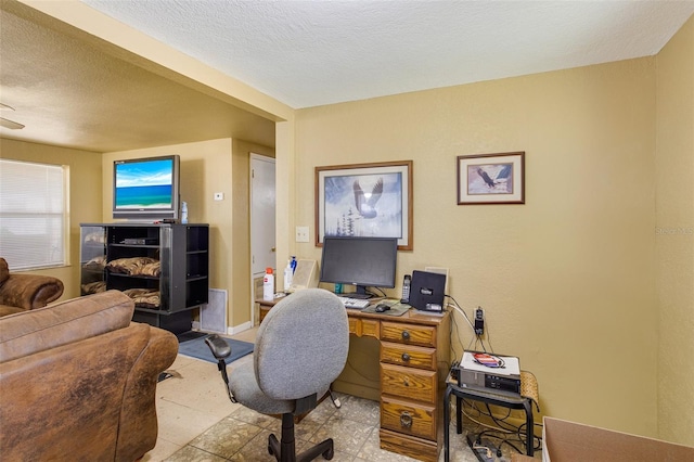 office space featuring baseboards and a textured ceiling