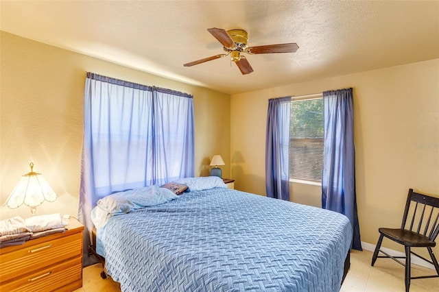 bedroom featuring light floors, baseboards, and ceiling fan