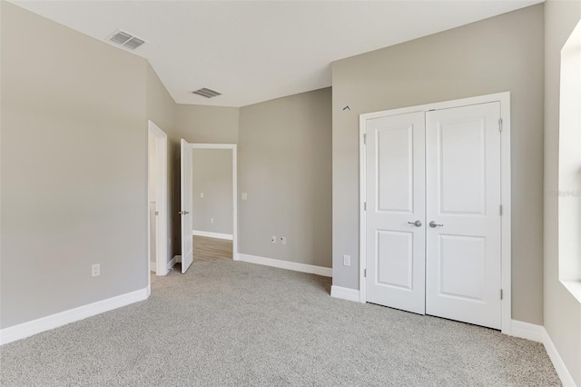 unfurnished bedroom with light carpet, baseboards, and visible vents