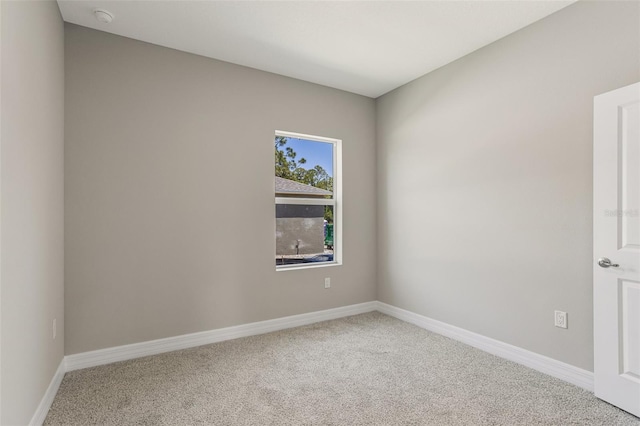 unfurnished room featuring baseboards and carpet flooring