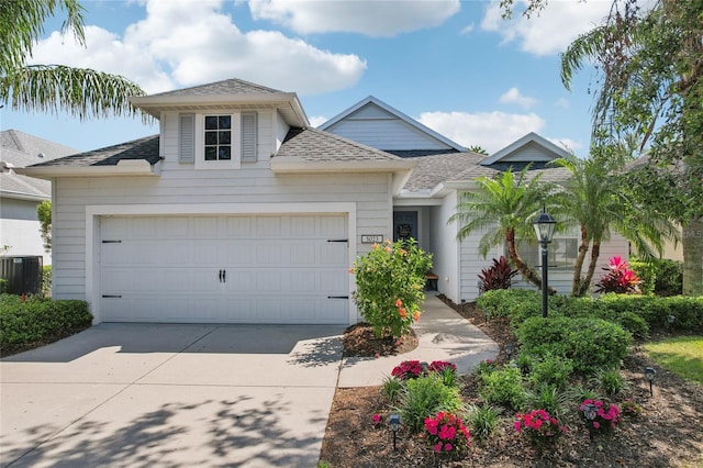 5023 Brickell Park Cv, Bradenton, FL 34211 - traditional-style house featuring roof with shingles, a garage, concrete driveway, and central AC