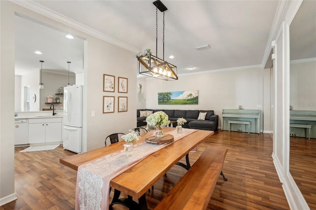 5023 Brickell Park Cv, Bradenton, FL 34211 - dining area featuring dark wood-style flooring, recessed lighting, ornamental molding, and baseboards
