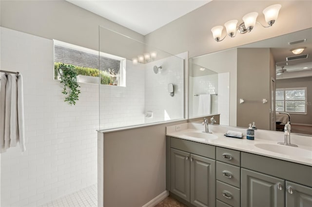 5023 Brickell Park Cv, Bradenton, FL 34211 - bathroom with double vanity, walk in shower, and a ceiling fan