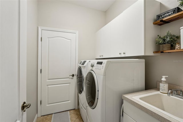 5023 Brickell Park Cv, Bradenton, FL 34211 - laundry room featuring washing machine and dryer, cabinet space, and light tile patterned flooring