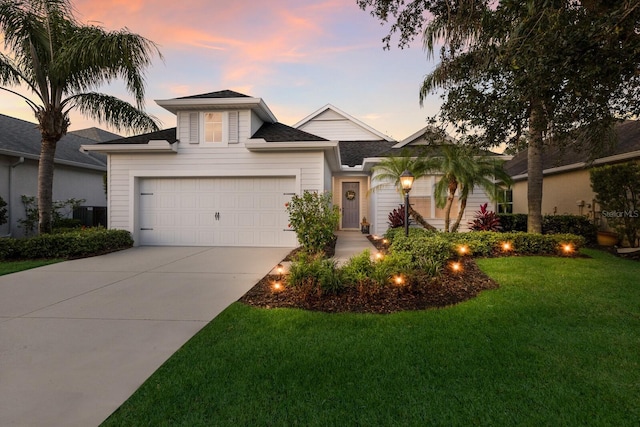 5023 Brickell Park Cv, Bradenton, FL 34211 - view of front of property featuring a lawn, an attached garage, driveway, and roof with shingles
