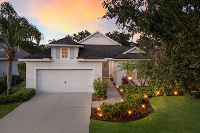 5023 Brickell Park Cv, Bradenton, FL 34211 - view of front of house featuring a shingled roof, a lawn, driveway, and a garage