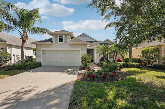 5023 Brickell Park Cv, Bradenton, FL 34211 - view of front facade featuring concrete driveway, central AC, an attached garage, a front lawn, and roof with shingles