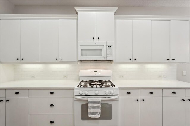 5023 Brickell Park Cv, Bradenton, FL 34211 - kitchen featuring white appliances, light countertops, backsplash, and white cabinets