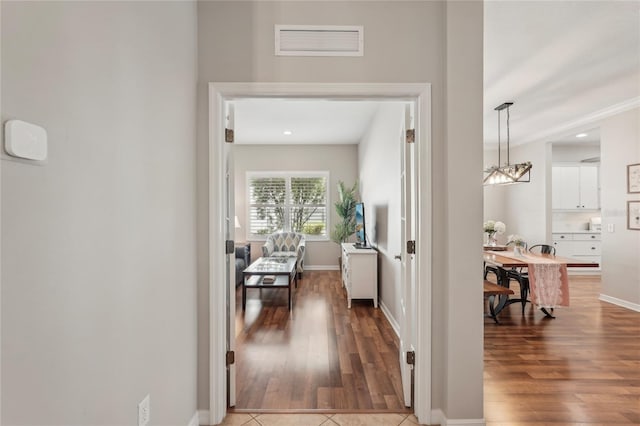 5023 Brickell Park Cv, Bradenton, FL 34211 - hall with wood finished floors, a chandelier, baseboards, and recessed lighting
